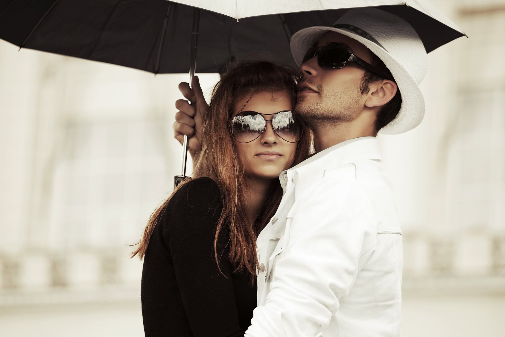 Young fashion couple in love with umbrella outdoor